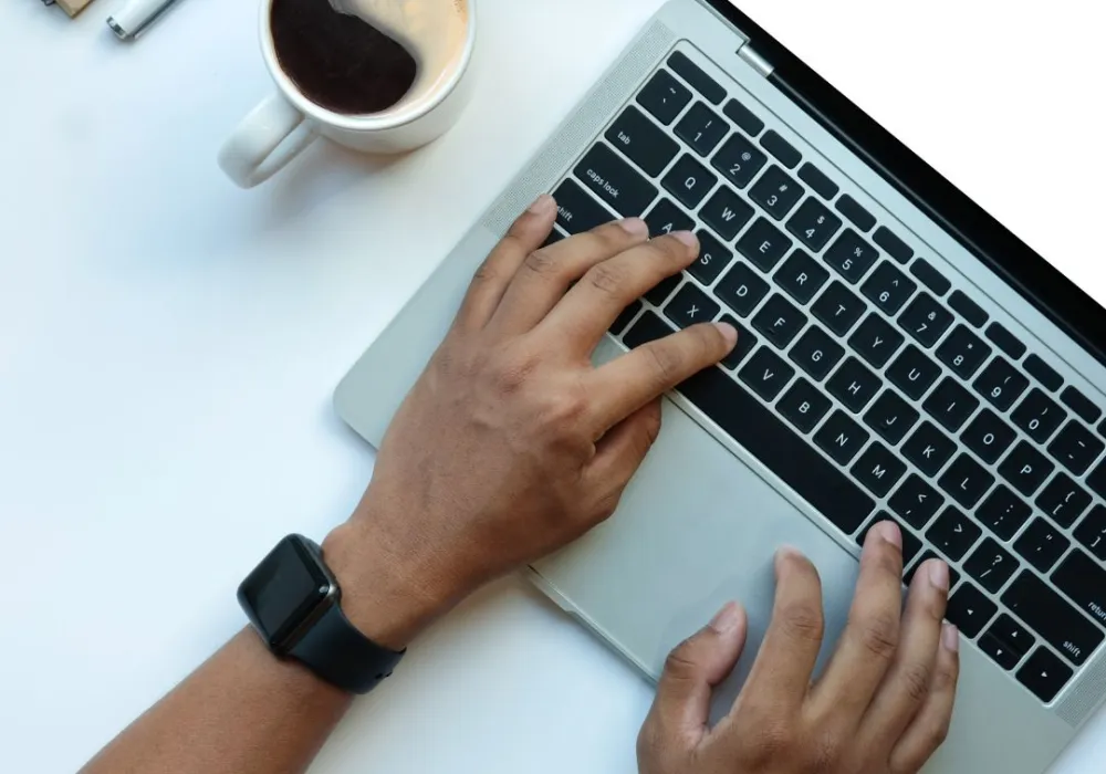 Someone typing on a laptop