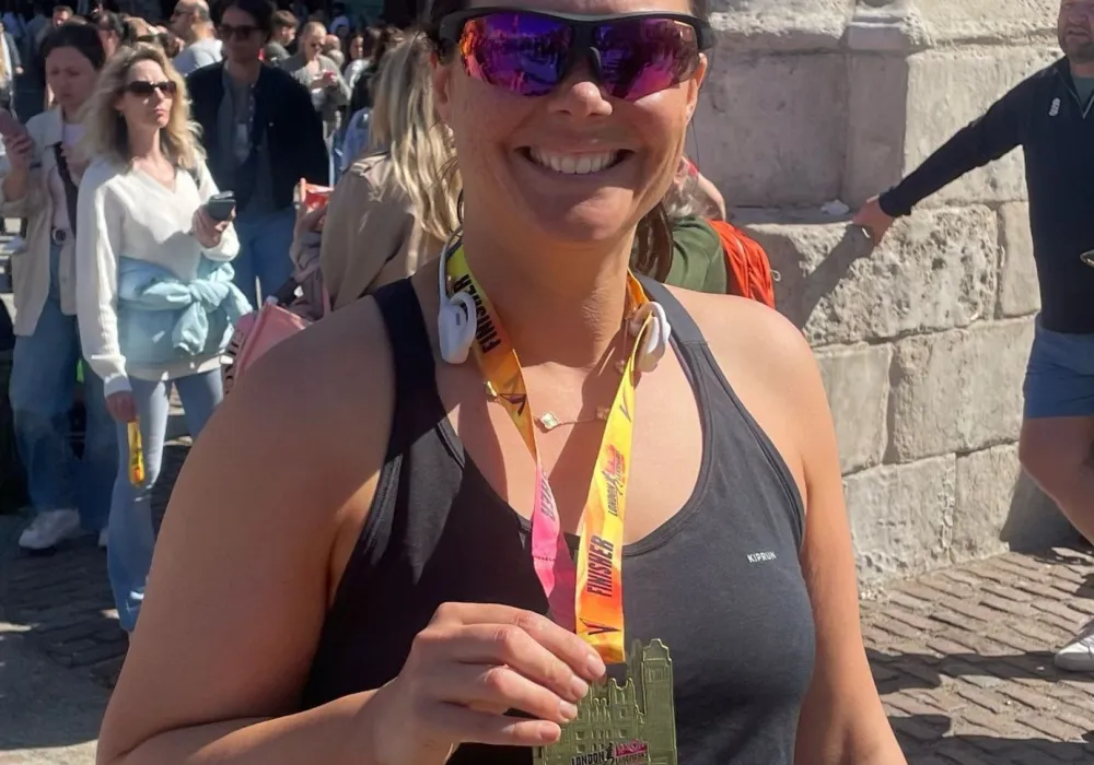 Suzy with her medal at the half marathon finish line!