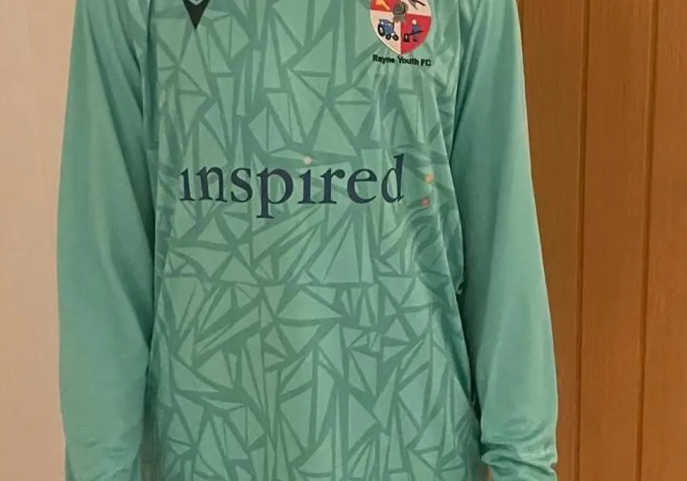 image of the inspired logo on the grass roots football club shirt
