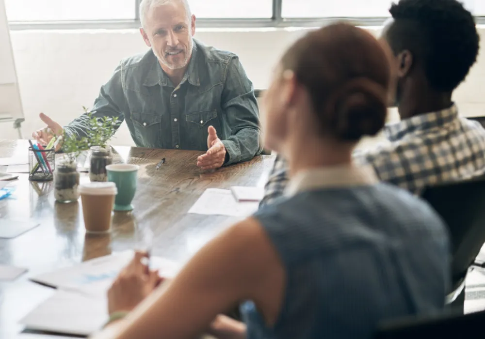 business meeting, 3 people in a board room